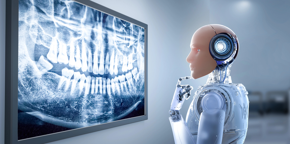A humanoid robot examines a dental X-ray image displayed on a screen in a clinical setting.